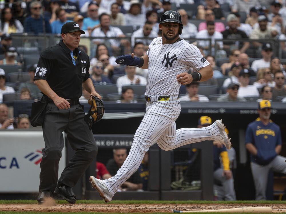New York Yankees' Jasson Domínguez (24) scores during the third inning of a baseball game against the Milwaukee Brewers, Saturday, March 29, 2025, in New York.