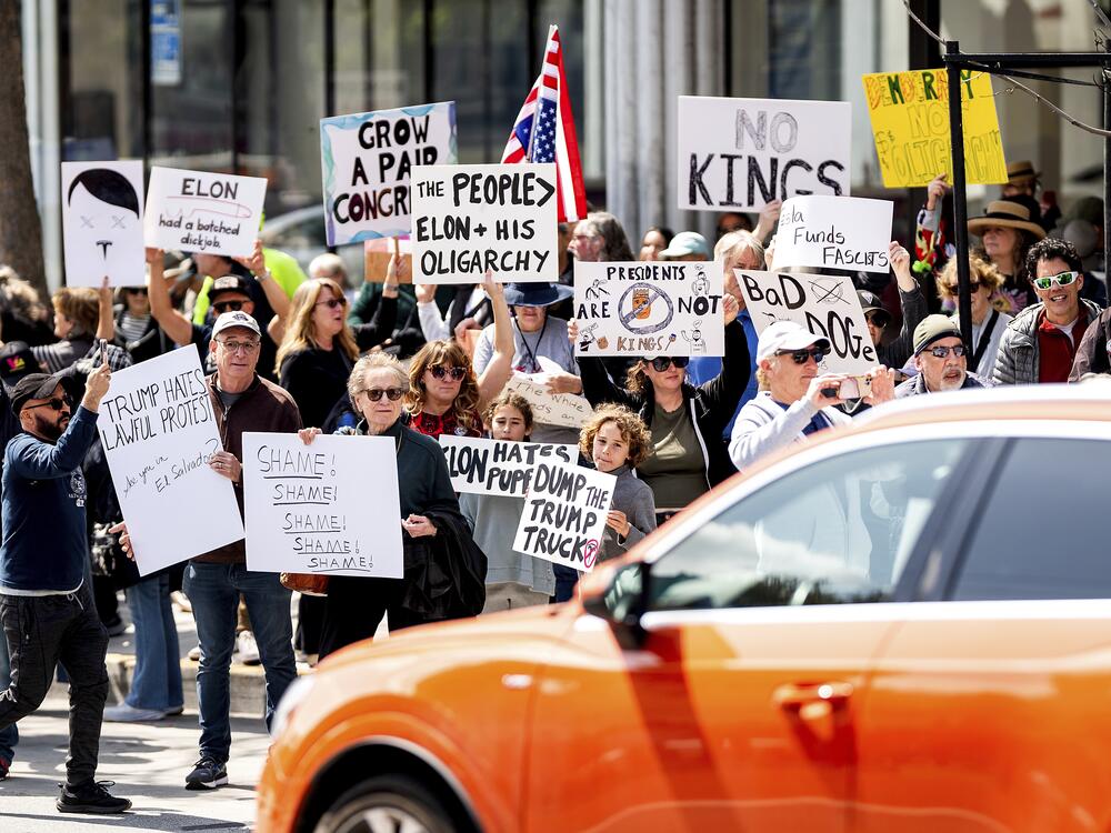 Protesters rally against Tesla CEO Elon Musk outside a Tesla store in San Francisco on Saturday.