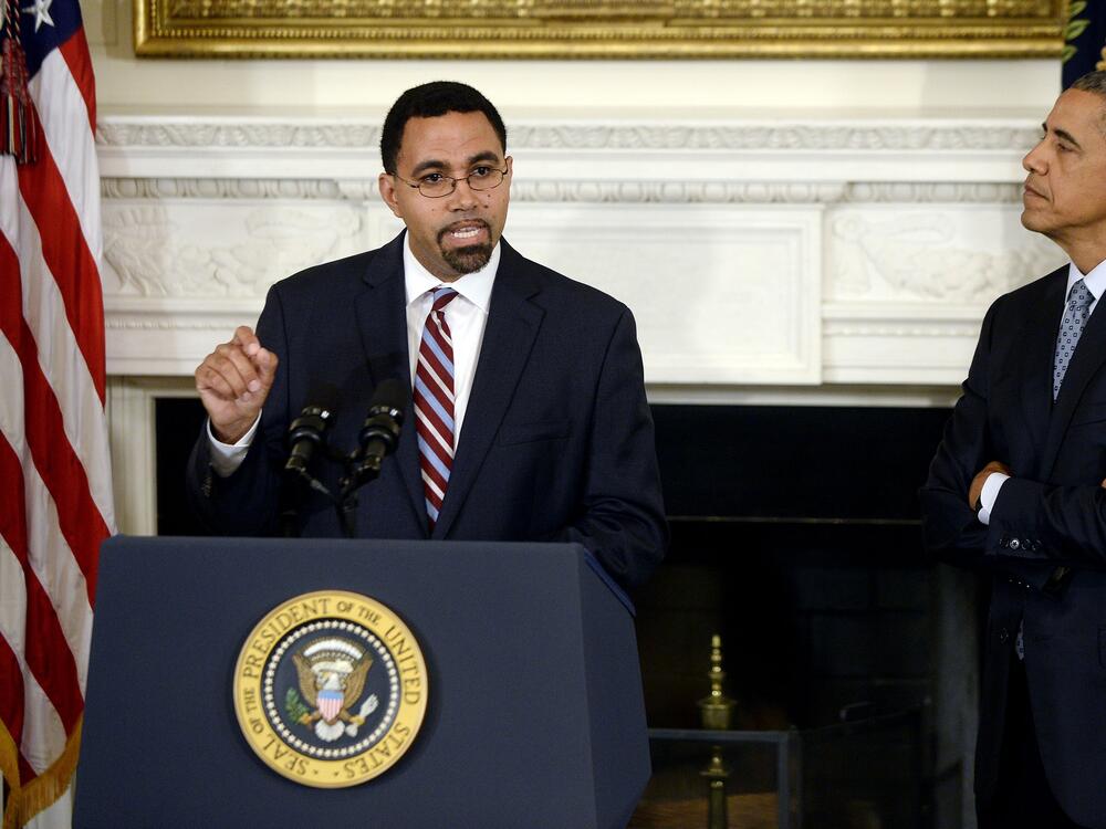 Former Education Secretary John B. King Jr. (L) with President Obama at the White House in October 2015.