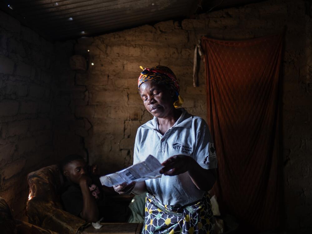 Community health mobilizer Rose Asabi, 58, scans through a list containing the details of the 515 children from her immediate area who are suffering from lead poisoning. Asabi lives in Magandanyama, one of the neighborhoods worst affected by lead contamination caused by decades of mining and smelting in the town. Asabi's own grandchildren all have blood lead levels of between 45 and 89 micrograms per deciliter, a level that requires urgent medical treatment — the safe limit is considered to be no more than…