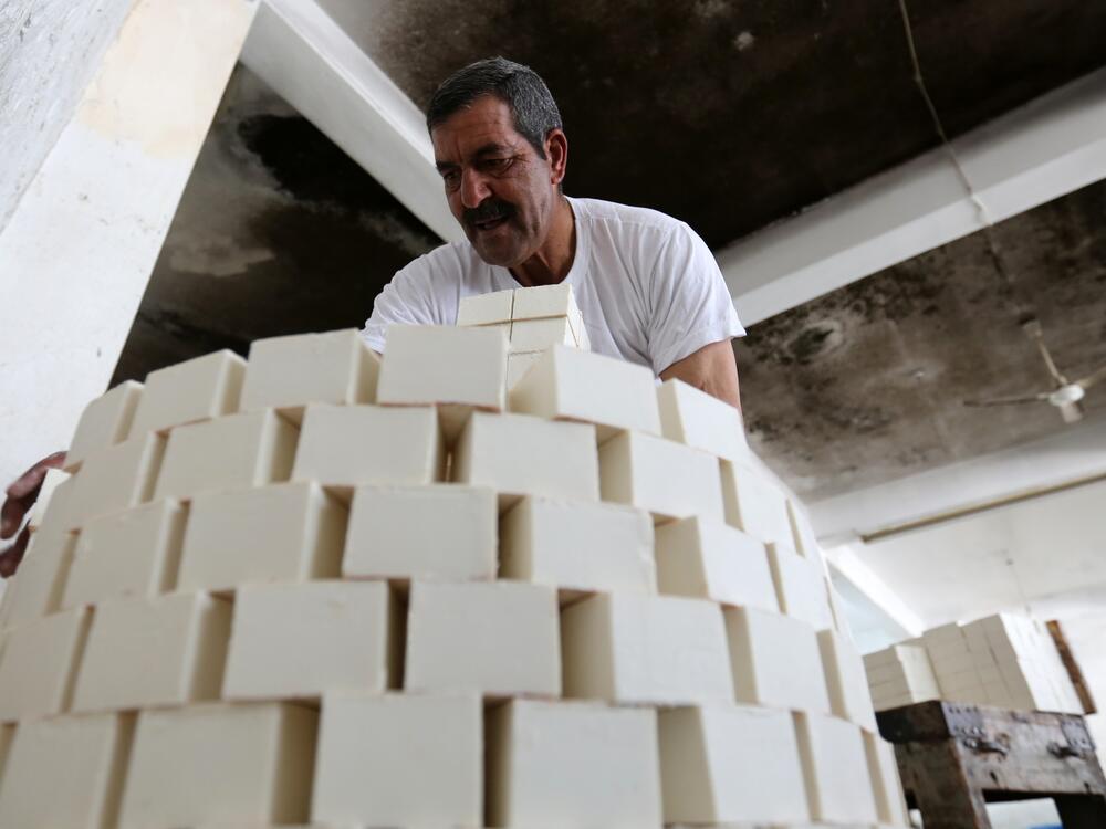 A worker stacks soap bars at the Touqan soap factory in Nablus, West Bank, on March 1.