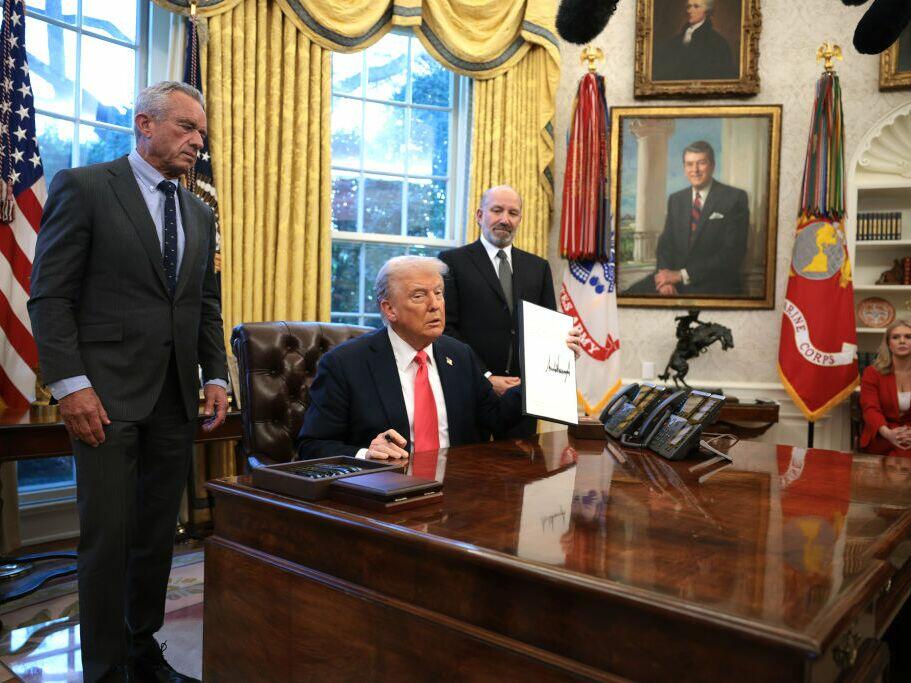President Trump, joined by Health and Human Services Secretary Robert F. Kennedy Jr. (left) and Commerce Secretary Howard Lutnick (right), signs an executive order on Feb. 25 on price transparency requirements for the health care industry.