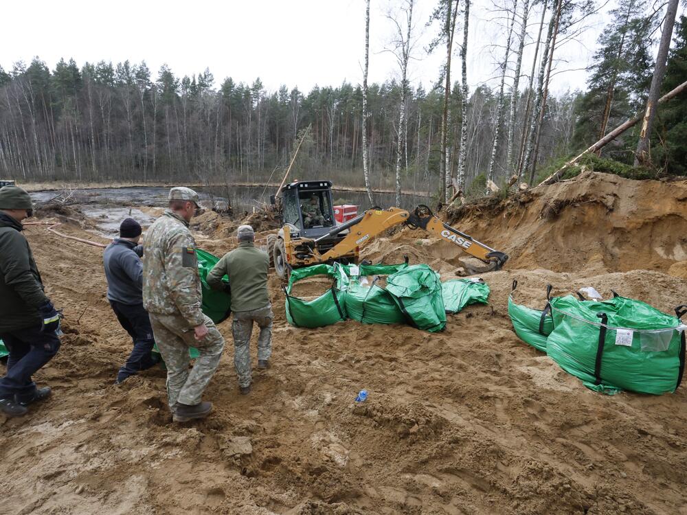 Military personnel work at the site of a rescue operation for missing U.S. soldiers at Pabradė training ground, in Lithuania, on Friday.