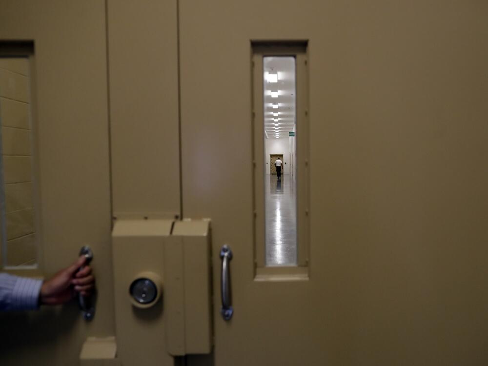 A man walks in a hallway at the Otay Mesa Detention Center Wednesday, Aug. 23, 2017, in San Diego.
