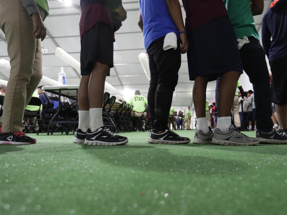 Immigrants line up in the dining hall at a U.S. government holding center for migrant children, July 9, 2019, in Carrizo Springs, Texas.