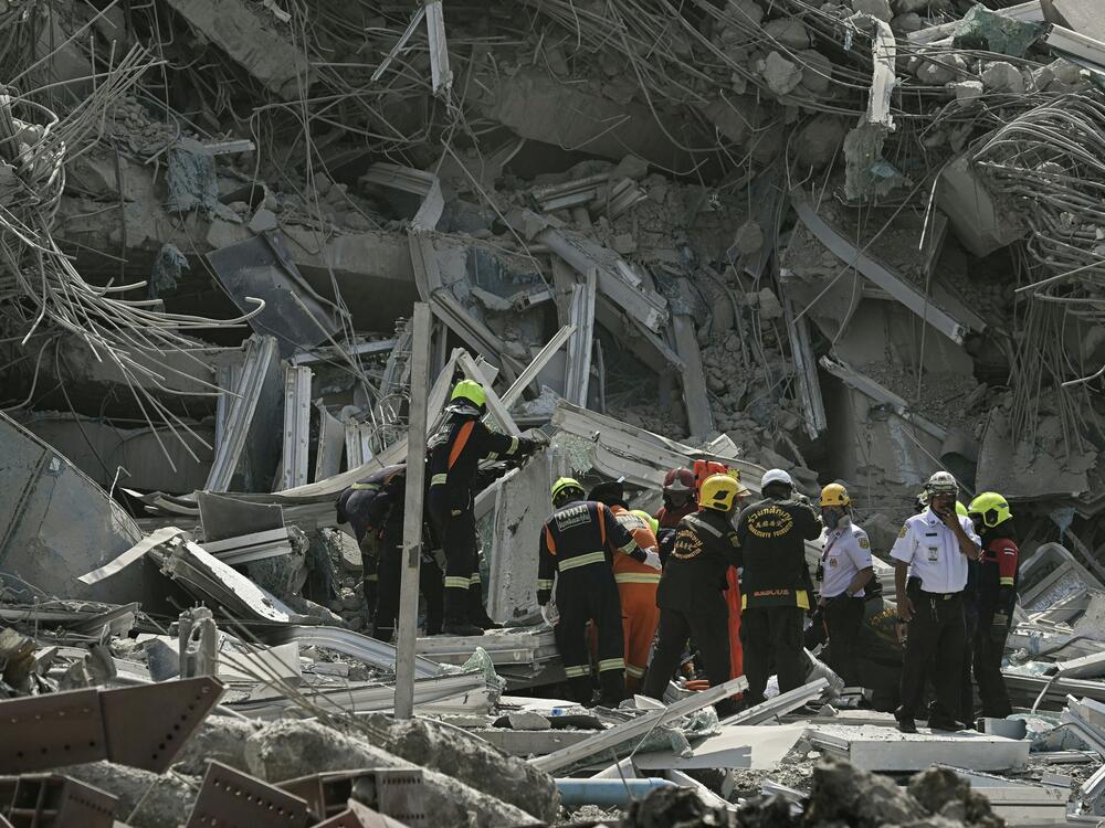 Rescue teams are seen at a site where a building collapsed in Bangkok on March 28 after an earthquake. The powerful earthquake rocked central Myanmar, buckling roads in the capital Naypyidaw, damaging buildings and affecting neighboring Thailand as well, where people fled into the streets for safety.