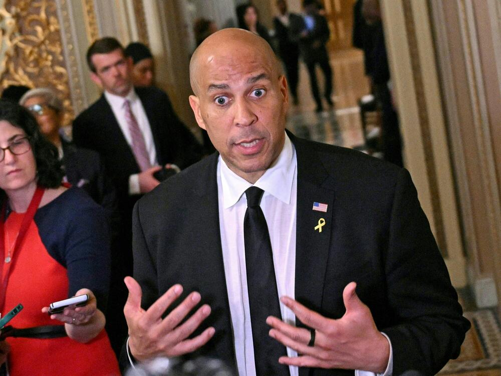 Sen. Cory Booker, D-N.J., speaks to journalists at the Capitol on Tuesday. Booker obliterated a record long held by the late Strom Thurmond, speaking out for more than 25 hours in protest against President Trump's actions since taking office in January.