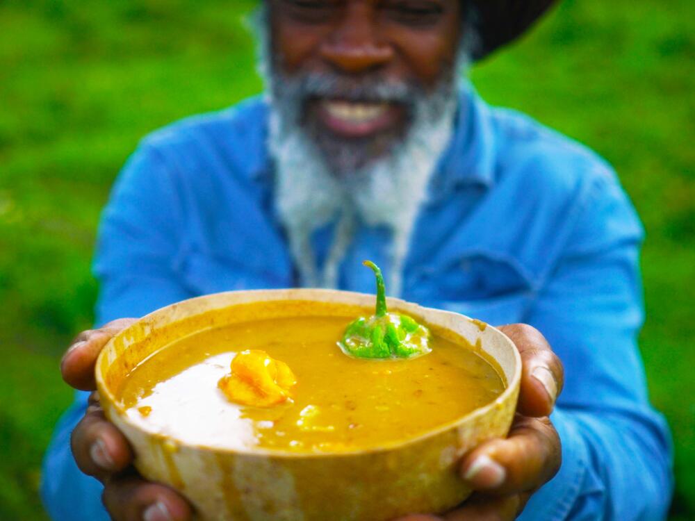 Chef Tony Allen presents a fresh bowl of <em>ital sip </em>in a hollowed-out calabash gourd.