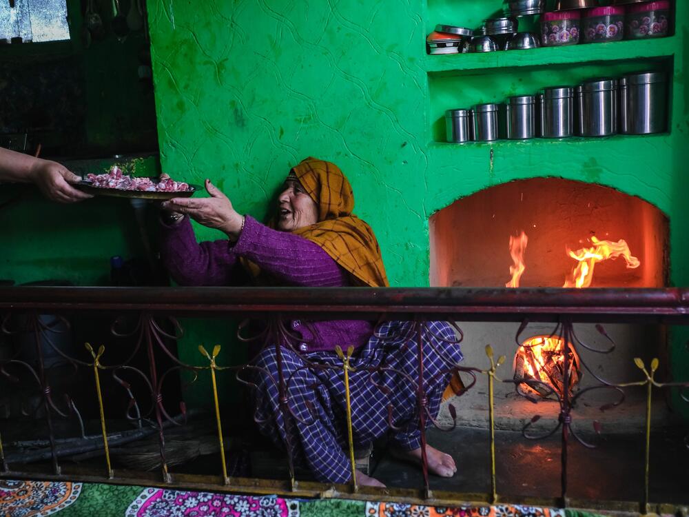 In the warmth of her kitchen, Arsha Begum's daughter-in-law hands her raw mutton to prepare <em>chatte rass</em>. Cooking over a traditional fireplace, Begum follows a time-honored process, slowly turning simple ingredients into a soothing, flavorful soup.