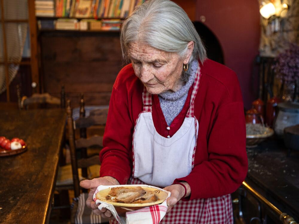 Angela Farre Palacin holds the soup she just prepared in the kitchen of Casa Leonardo, an inn that has been in the family for three generations and that serves traditional Catalan cuisine to its guests.