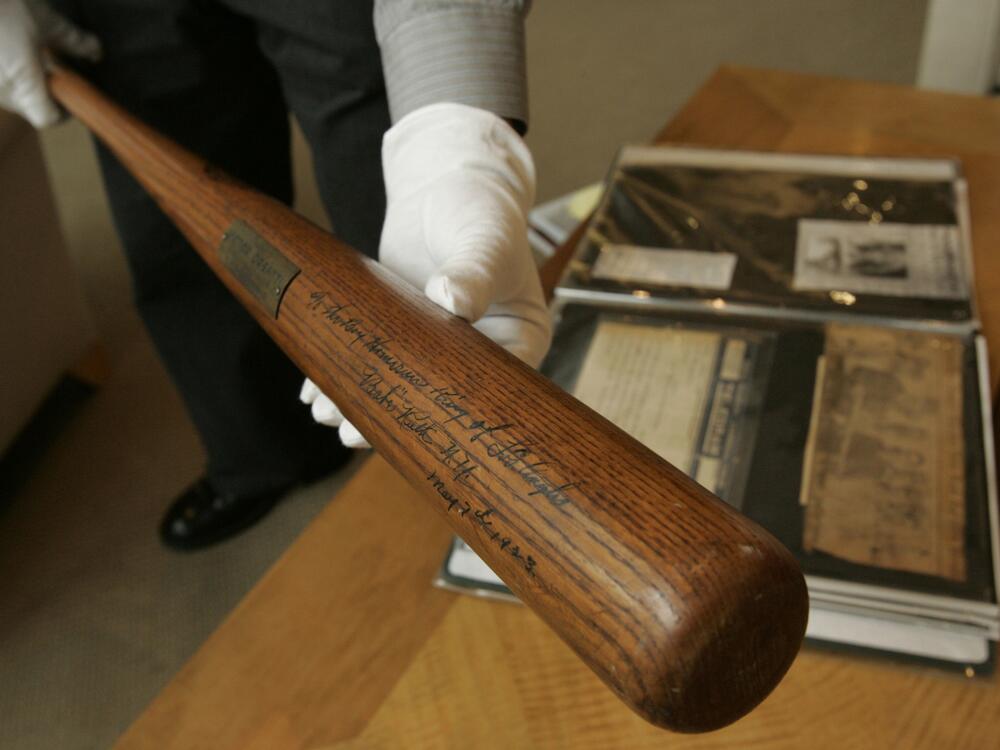 Babe Ruth used this bat to hit his first home run in Yankee Stadium in 1923; it's seen here in 2004 at Sotheby's in New York. Bat design hasn't changed much in more than 100 years, other than their weight dropping from above 40 ounces in Ruth's case to the current norm of around 31 or 32 ounces, baseball experts tell NPR.