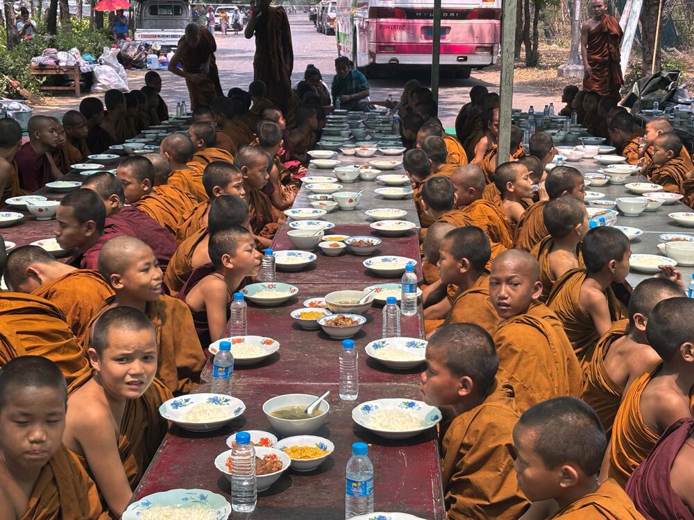 Buddhist novice monks sit under temporary shelter near a road, in the aftermath of Friday's earthquake in Mandalay, Myanmar on Wednesday.