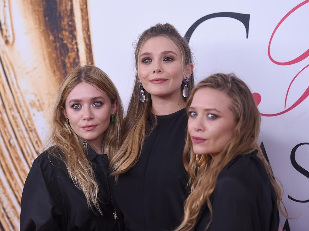 Elizabeth Olsen (center) and Mary-Kate and Ashley Olsen attend the 2016 CFDA Fashion Awards at the Hammerstein Ballroom in June 2016 in New York City.