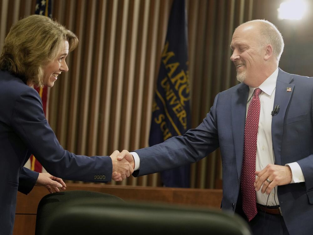 Wisconsin Supreme Court candidates Susan Crawford and Brad Schimel shake hands before a debate March 12 in Milwaukee.