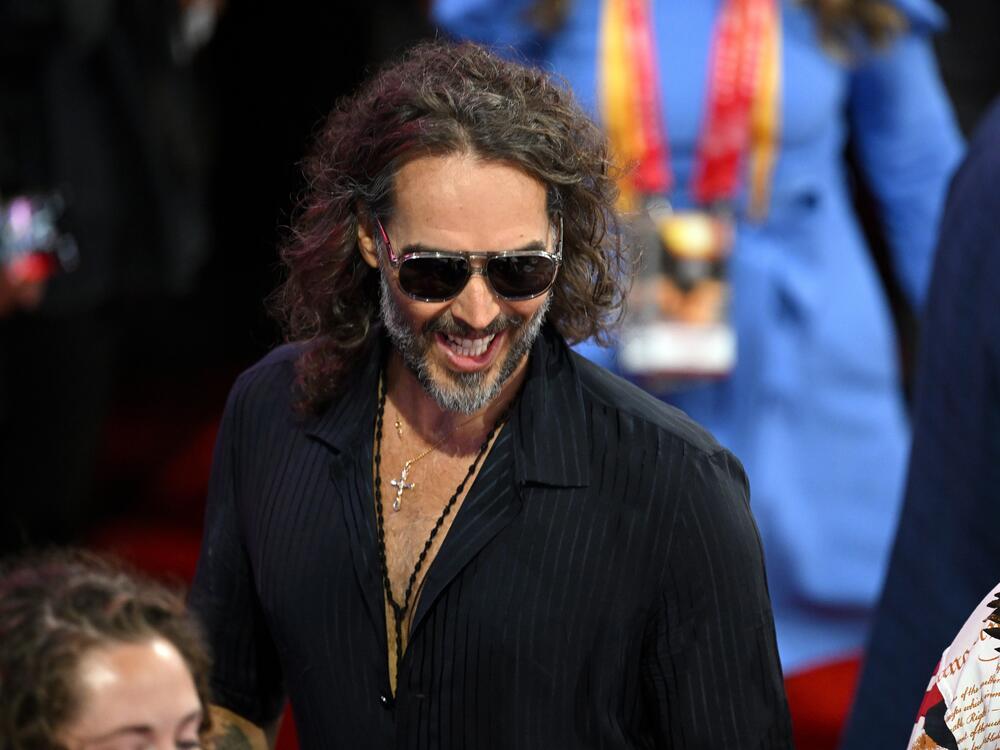 Comedian and actor Russell Brand is facing criminal charges in England over rape and sexual assault allegations that span some six years. He's seen here attending the Republican National Convention in July.