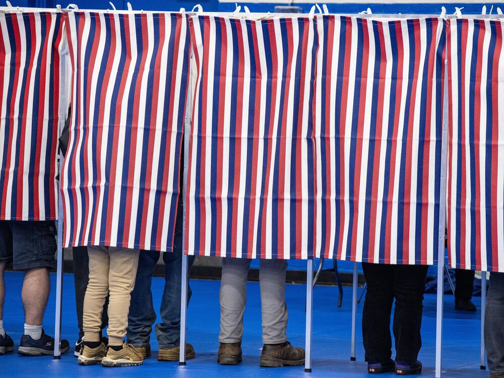 People fill out their ballots in voting booths at the Green Street Community Center in Concord, N.H., on Nov. 5, 2024.