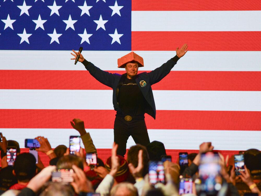 Elon Musk wears a cheesehead hat as he speaks during a rally in Green Bay, Wisc. on March 30, 2025. An election to choose a new state Supreme Court justice takes place Tuesday and Musk has contributed millions to the race, hoping to secure a win for the conservative candidate.