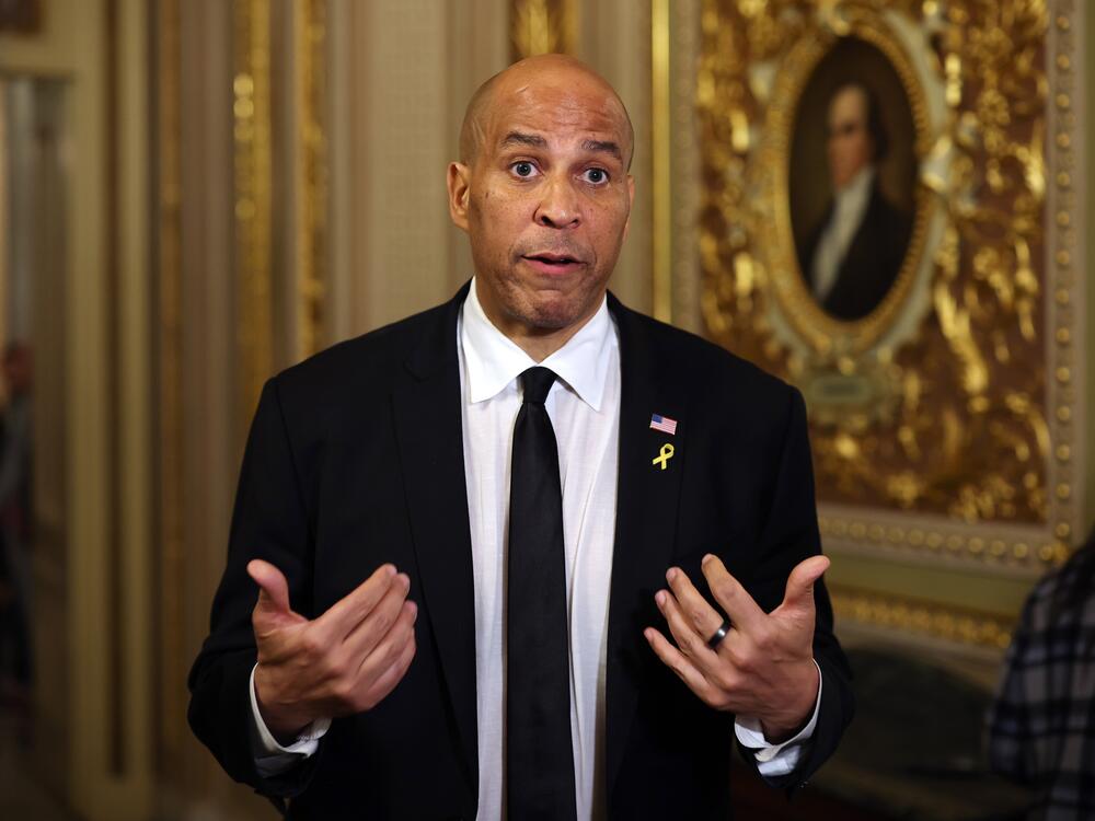 Sen. Cory Booker speaks to reporters as he leaves the Senate chamber after delivering a record-setting floor speech on Tuesday. Contrary to popular belief, the speech was not technically a filibuster.