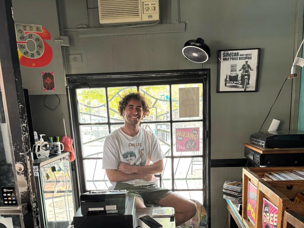 Nick Bonell sits in the Wuxtry record shop where then-employee Peter Buck met Michael Stipe. Shortly after, R.E.M. was born. Bonell, true to Athens form,  also plays in a band: The Asymptomatics.