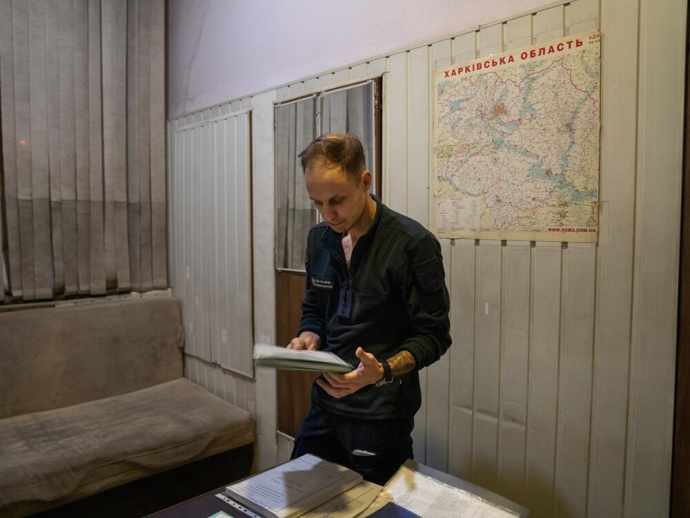 Volodymyr Lohinov stands in his office at the fire station where he works in Kharkiv. He sometimes tries to sleep on the couch in his office, but much of the time he is up at night filling out paperwork with details of the calls he went out on. He says it sometimes grounds him after major disasters. The only night he was relieved from doing paperwork was last April, when his father was killed.