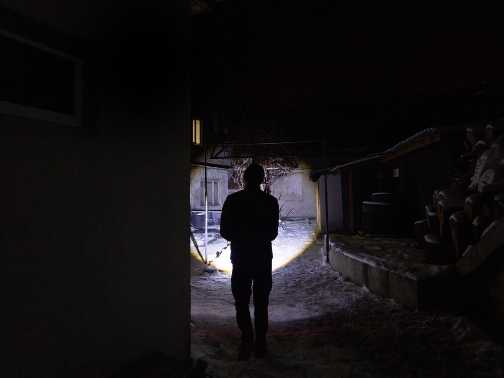 Lohinov uses a flashlight just to walk from one building to another at night in the fire station.
