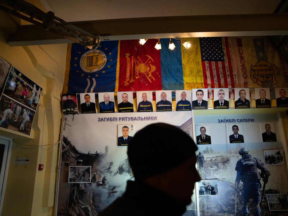 Lohinov stands in a small museum for Kharkiv firefighters, which was never opened to the public since it wasn't finished before the war began. Now it has a wall that is dedicated to those who have died on duty during the war, including Lohinov's father, Vladyslav Lohinov.