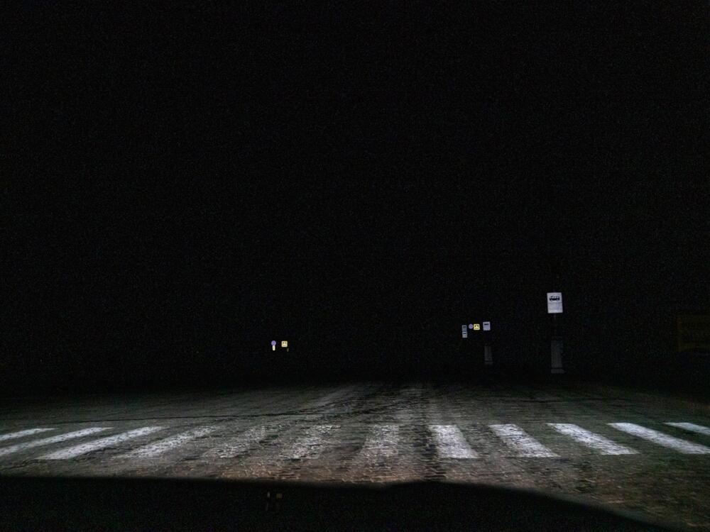 Downtown Kharkiv is filled with large historic buildings, but at night, after curfew, things are barely visible due to the streetlights being shut off.