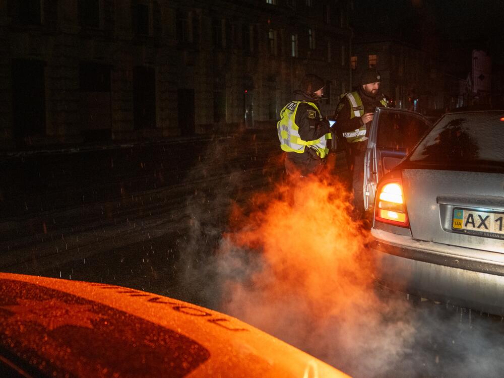 Police stop cars in downtown Kharkiv that are on the road just after the city's 11 p.m. curfew. The only people allowed out after curfew are in a few categories like emergency responders, medical workers, military and police.