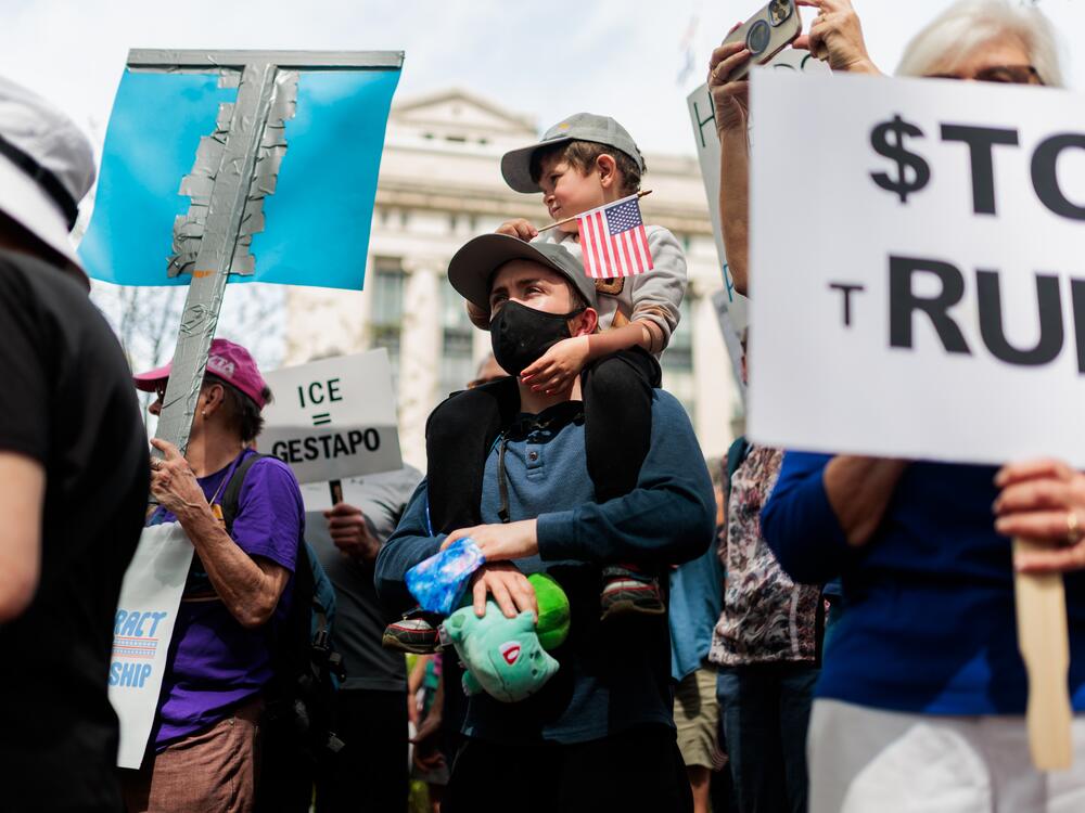 Peter Gregory, protests with his son, Felix, 5, along with others gathered at the Virginia State Capitol to protest the Trump administration's policy on Saturday, April 5, 2025 in Richmond, Virginia.