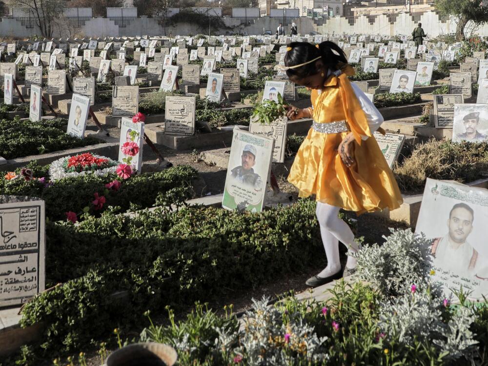 A Yemeni girl visits the graves of Houthis during Eid al-Fitr marking the end of the holy fasting month of Ramadan in Sanaa, Yemen, Sunday, March 30, 2025.