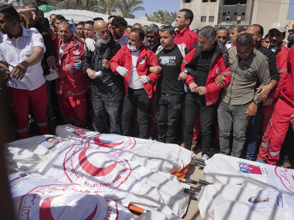 Mourners gather around the bodies of eight Red Crescent emergency responders, recovered in Rafah a week after an Israeli attack, as they are transported for burial from a hospital in Deir al-Balah, Gaza Strip, March 31.