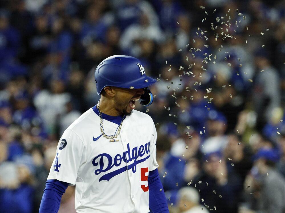 Los Angeles Dodgers' Mookie Betts is showered with sunflower seeds after hitting a two-run home run against the Atlanta Braves during the sixth inning of a baseball game Tuesday in Los Angeles.