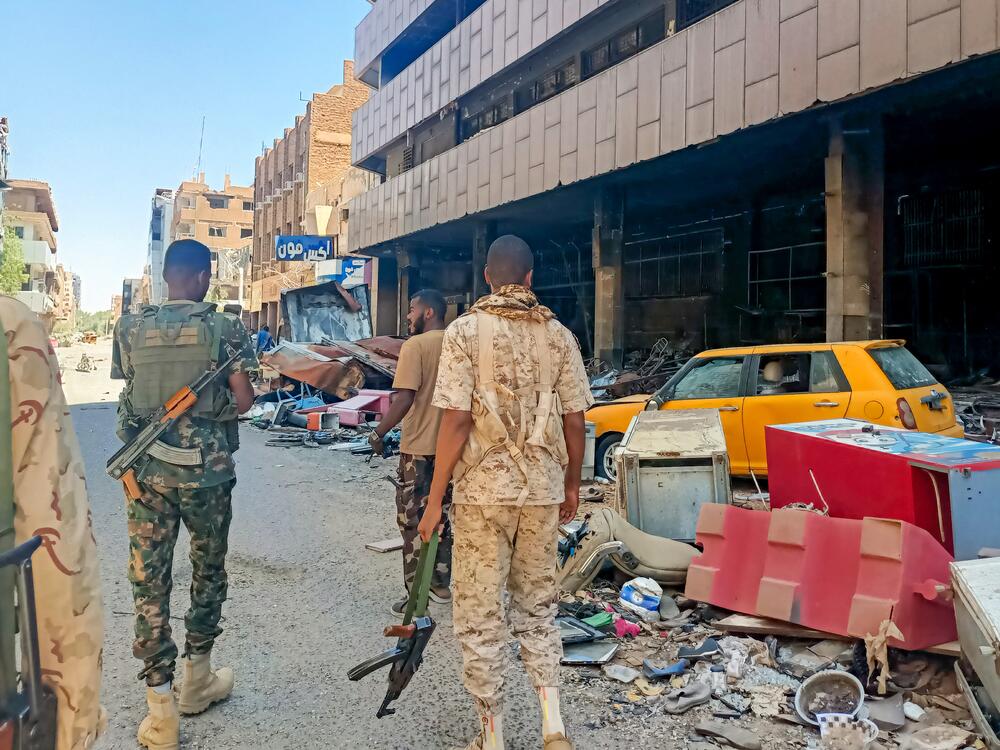 Army soldiers patrol a market area in Khartoum.