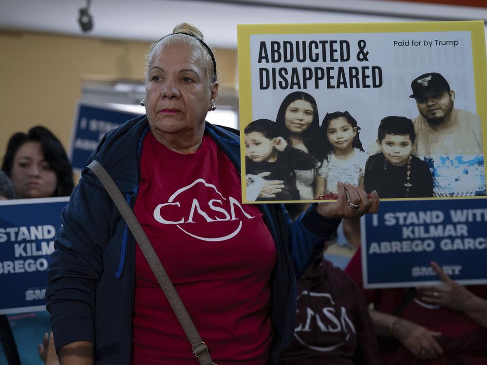 Supporters hold up signs as Jennifer Vasquez Sura, the wife of Kilmar Abrego Garcia of Maryland, who was mistakenly deported to El Salvador, speaks during a news conference at CASA's Multicultural Center in Hyattsville, Md., Friday, April 4.
