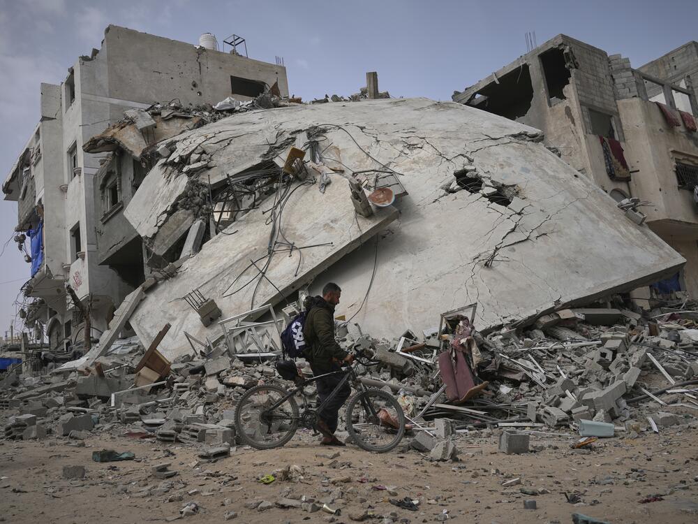 A man passes by the destroyed house of journalist Islam Meqdad, where she was killed along with her son and five other family members in an Israeli army strike in Khan Younis, southern Gaza Strip, Sunday, April 6, 2025.