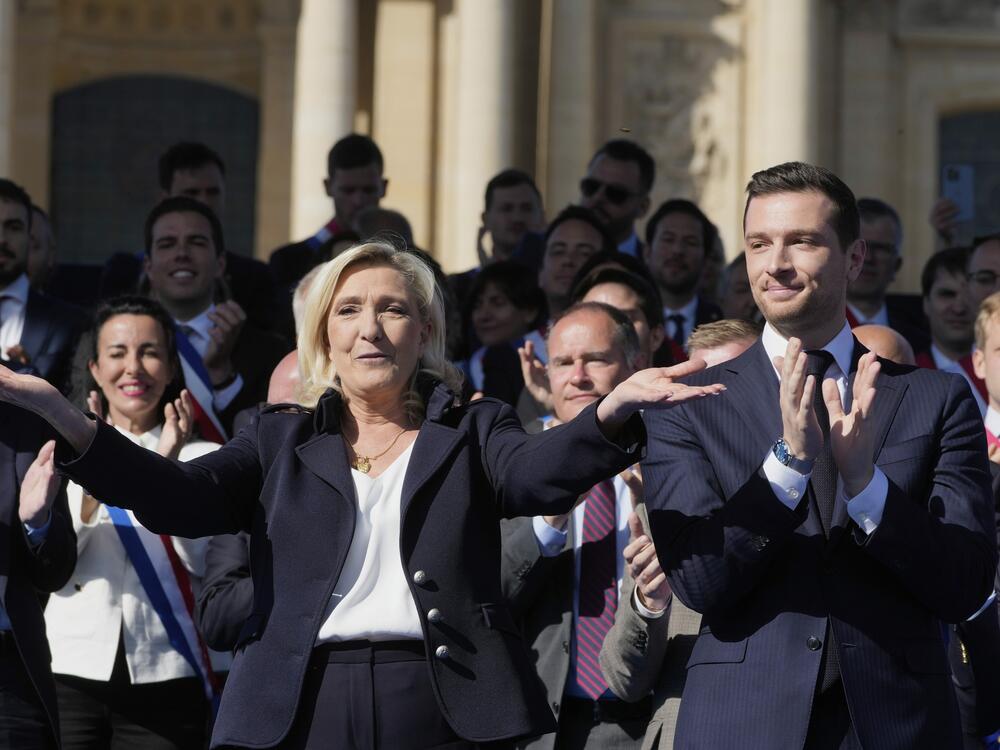 French far-right leader Marine Le Pen, left, reacts with Jordan Bardella during the French far-right party national rally near the parliament in Paris on Sunday.