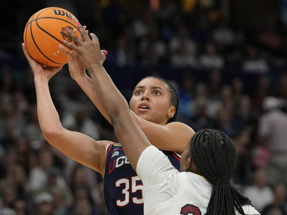 UConn guard Azzi Fudd (35) shoots against South Carolina forward Sania Feagin (20) during the first half of the national championship game of the women's NCAA college basketball tournament on Sunday in Tampa, Fla.