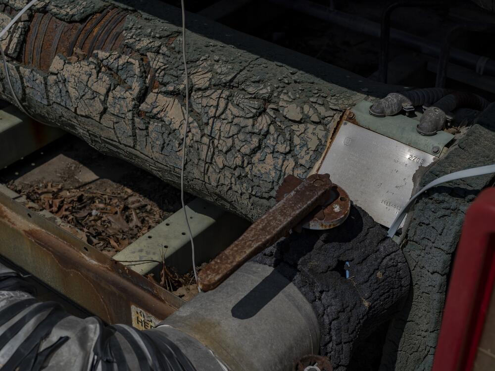 Rusty patches and cracked rubber insulation on the 1993 chiller at Trinity Woods, which died three years ago. The Inflation Reduction Act of 2022 included a program to help hundreds of affordable housing operators upgrade aging infrastructure, but the Trump administration has halted that funding.
