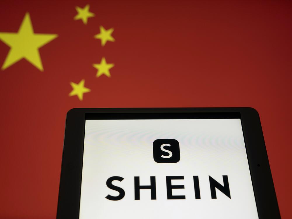 The Shein logo arranged against a Chinese flag in Shanghai, China, on Monday, Feb. 3, 2025.  China is retaliating against the U.S. after President Trump implemented tariffs that affect small purchases as well as whole industries.