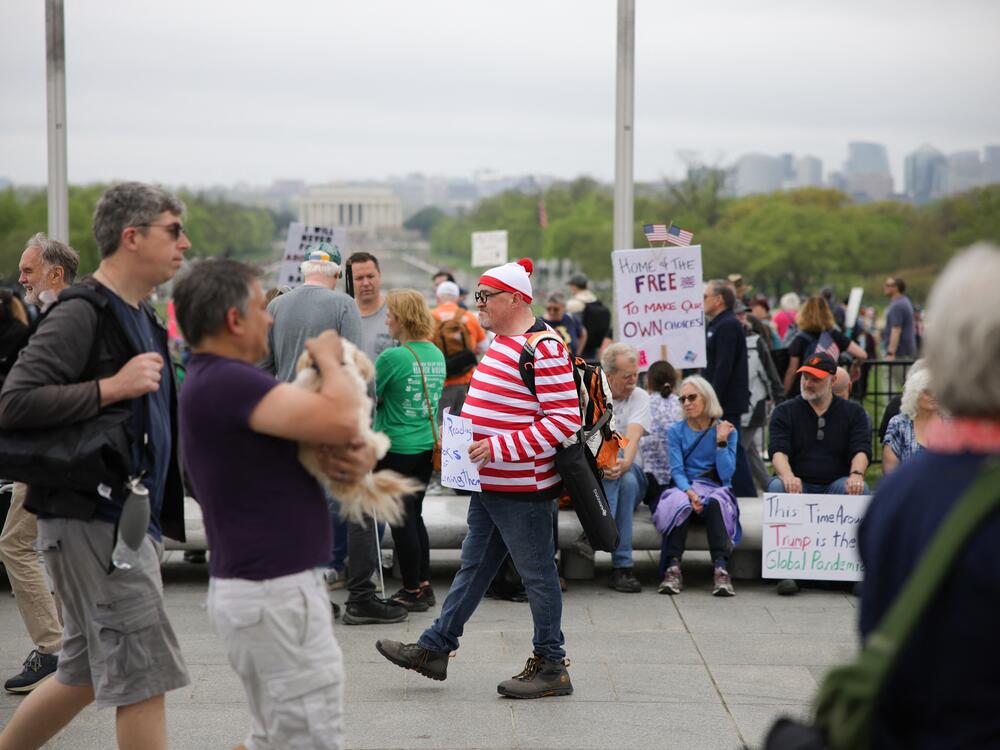 A demonstrator is dressed as the fictional character Waldo during the 