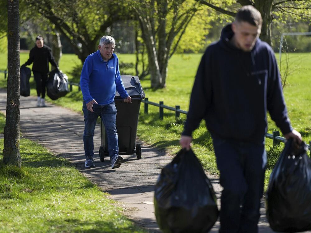 Local residents deliver rubbish to mobile collection vehicles in Erdington, Birmingham, England on Monday.