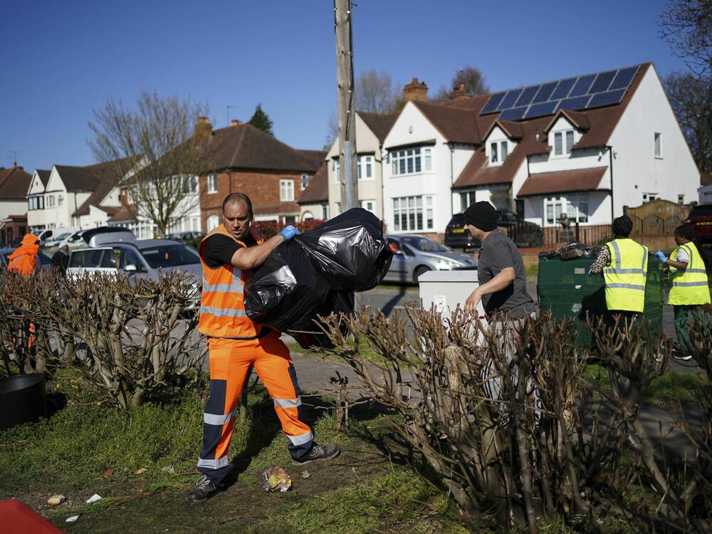 Local residents deliver rubbish to mobile collection vehicles in Erdington, Birmingham, England on Monday.