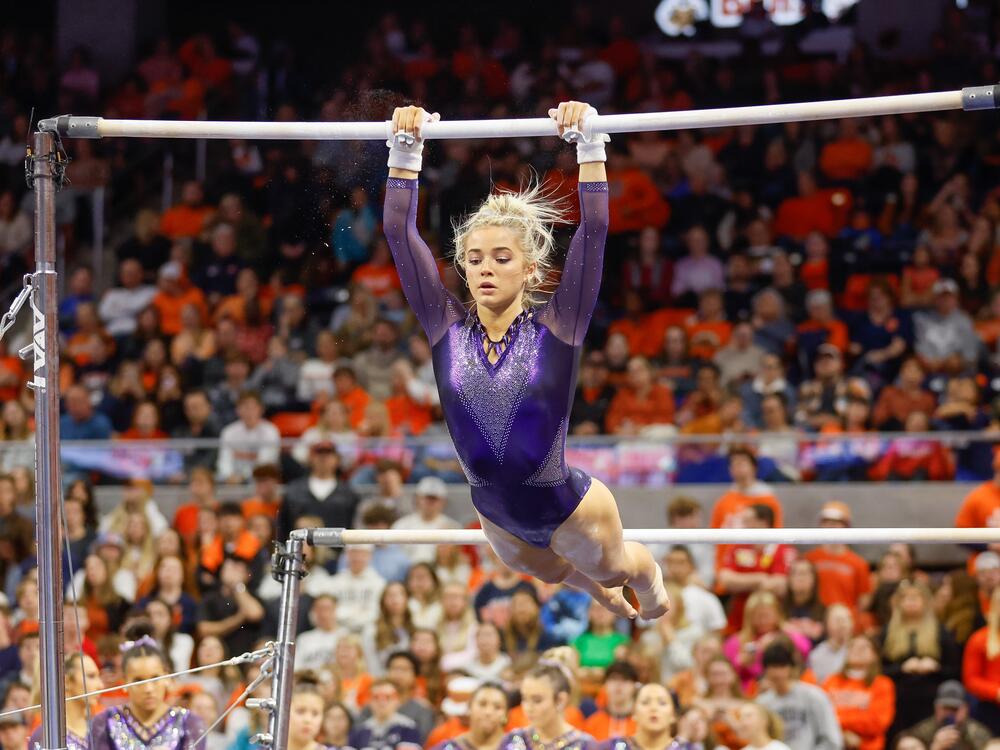 LSU gymnast Livvy Dunne, shown here competing at Auburn University on February 10, 2023, is the highest-earning female athlete in college athletics. She objects to the proposal saying she earned nothing in her freshman year nor while she was in high school due to NCAA rules.
