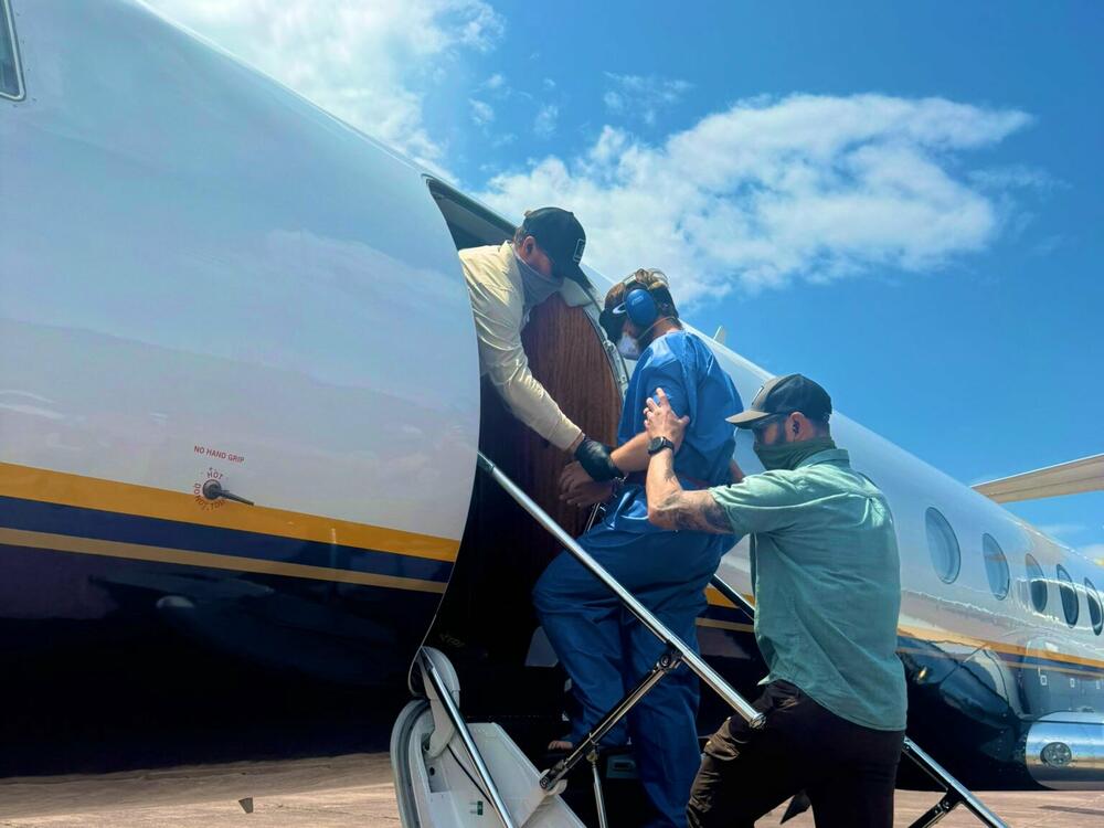 The three American men board a plane in Kinshasa.