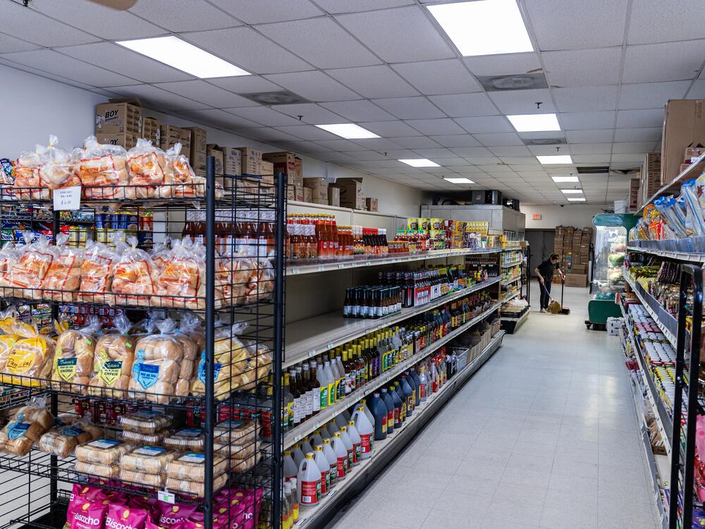 A worker sweeps the floor at the Manila Oriental Market in Springfield, Va.  The market sells many imported items from the Philippines and other Asian countries.