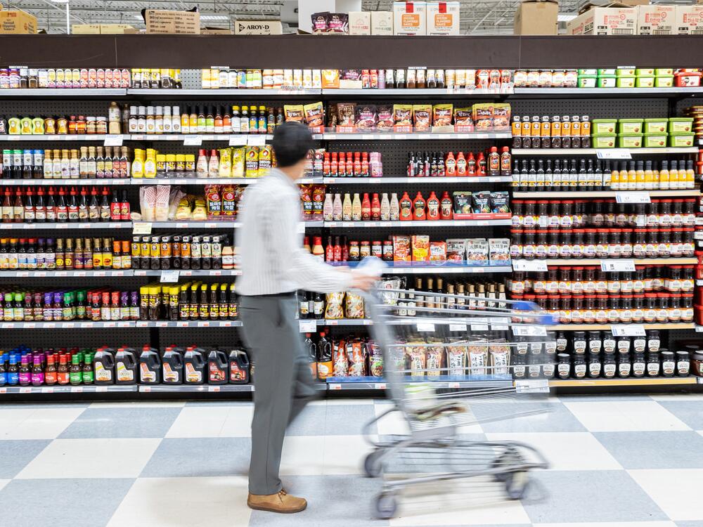 A shopper is walking past a shelf filled with soy sauce and gochujang at Lotte Plaza Market in Centreville, Va., on Friday. Many of the store's products are imported from Asian countries that have been hit with tariffs, which will likely cause prices to rise for consumers.