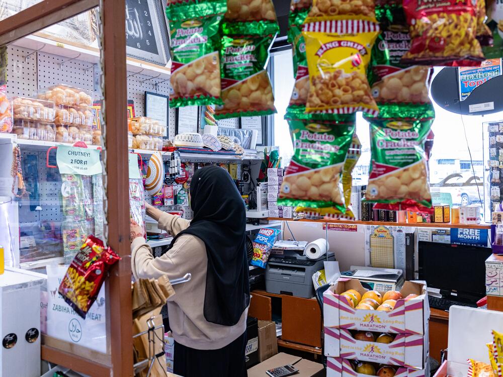 Dola Hossain, the manager of Paak Bangla Bazaar in Falls Church, Va., at work on April 4.
