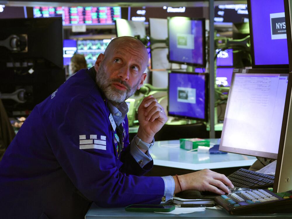 A trader works on the floor of the New York Stock Exchange (NYSE) at the opening bell on Tuesday. Stocks were modestly higher on Wednesday, although investors remained on edge after four days of heavy losses.