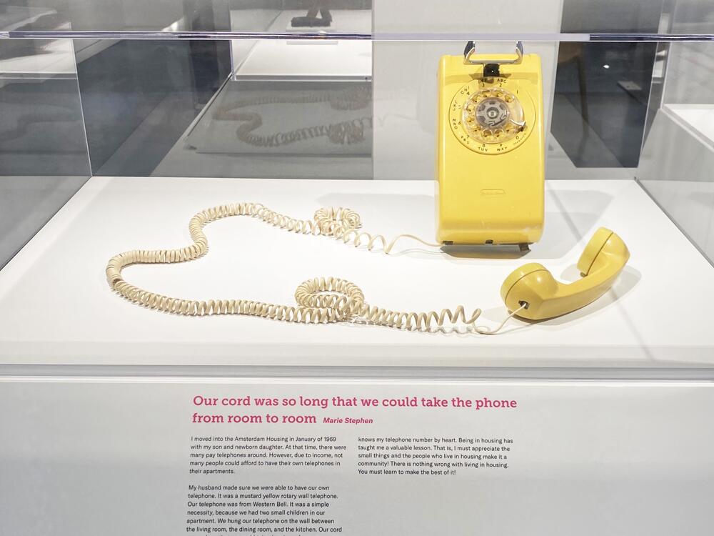 Yellow rotary dial phone, pictured in the 