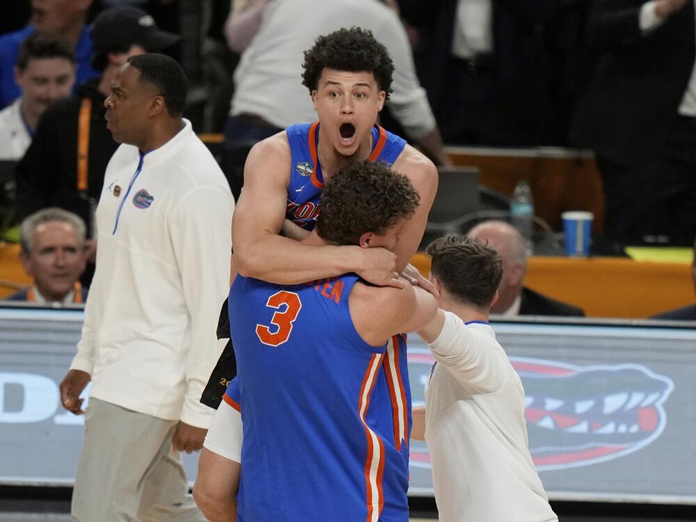 Florida's Micah Handlogten (3) and Walter Clayton Jr. celebrate after Florida beat Houston in the national championship at the NCAA college basketball tournament, Monday, in San Antonio.